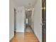 Bright hallway with hardwood floors, neutral walls, and multiple doors leading to various rooms at 4607 Ravenwood Loop, Union City, GA 30291