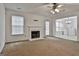 Spacious living room features a fireplace, windows, and a view into the kitchen area at 4607 Ravenwood Loop, Union City, GA 30291