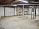 Unfinished basement space with a garage door, exposed ceiling, and concrete floor for flexible usage at 5535 Beaver Sw Dr, Mableton, GA 30126