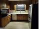 Traditional kitchen design, featuring wood cabinetry and stainless steel appliances at 5535 Beaver Sw Dr, Mableton, GA 30126