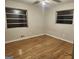 Bedroom with hardwood flooring, large windows, ceiling fan, and fresh paint at 5535 Beaver Sw Dr, Mableton, GA 30126