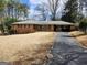 Charming one-story brick home with covered parking and a spacious front yard at 5535 Beaver Sw Dr, Mableton, GA 30126