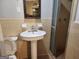 Clean bathroom showcasing tile flooring, a standing sink, toilet, and glass-enclosed shower at 5535 Beaver Sw Dr, Mableton, GA 30126
