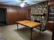 Living room with wood panel walls and a stone fireplace as a beautiful focal point at 5535 Beaver Sw Dr, Mableton, GA 30126