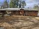 View of the brick home exterior, including a spacious backyard and connecting roof at 5535 Beaver Sw Dr, Mableton, GA 30126