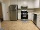 Kitchen featuring white cabinetry, stainless steel appliances, and a neutral backsplash at 1725 Sara Se Ct, Conyers, GA 30013