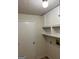 Laundry room with storage cabinets and an adjacent door at 1725 Sara Se Ct, Conyers, GA 30013