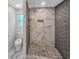 Updated bathroom features a beautifully tiled shower with rain shower head and mosaic flooring at 2117 Keheley Dr, Decatur, GA 30032