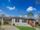 Charming single-story home with a carport, landscaped front yard, and inviting entryway with wooden steps at 2117 Keheley Dr, Decatur, GA 30032