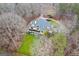 Aerial view of a yellow house with a circular driveway and two-tiered porch surrounded by trees at 160 Allie Dr, Mcdonough, GA 30252