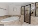 Spa-like bathroom featuring tile flooring, soaking tub, and glass enclosed shower at 160 Allie Dr, Mcdonough, GA 30252