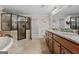 Bathroom with dual sink granite vanity, soaking tub, and glass enclosed tiled shower at 160 Allie Dr, Mcdonough, GA 30252