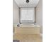 Bright bathroom features a large soaking tub and a window with sheer white curtains at 160 Allie Dr, Mcdonough, GA 30252
