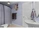 Bathroom featuring blue walls, decorative art, and a combined shower and bathtub at 160 Allie Dr, Mcdonough, GA 30252