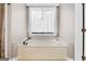 Relaxing bathtub with neutral tones and a window at 160 Allie Dr, Mcdonough, GA 30252