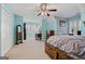Large primary bedroom with a wood bed frame, blue walls, and white carpet at 160 Allie Dr, Mcdonough, GA 30252
