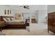 Spacious bedroom with neutral carpet, wood furniture, and a view of the backyard at 160 Allie Dr, Mcdonough, GA 30252