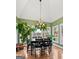 Bright dining area with views from large windows, vaulted ceilings, and hardwood floors at 160 Allie Dr, Mcdonough, GA 30252