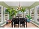 Dining area with large windows looking out onto a scenic view, vaulted ceilings, and hardwood floors at 160 Allie Dr, Mcdonough, GA 30252