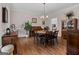 Dining room featuring hardwood floors, vintage-style buffet and table, with a view into the kitchen at 160 Allie Dr, Mcdonough, GA 30252