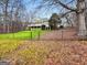 View of a two-story yellow home with a white porch and a fenced yard on a winter's day at 160 Allie Dr, Mcdonough, GA 30252