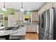 Well-equipped kitchen features stainless steel appliances, granite countertops, and hardwood floors at 160 Allie Dr, Mcdonough, GA 30252