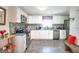 Updated kitchen featuring white cabinets, stainless steel appliances, granite countertops, and a mosaic tile backsplash at 2984 Bayard Ne St, East Point, GA 30344