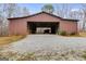 Large barn with open interior and gravel drive on a landscaped lot at 630 Stoney Point Rd, Bowdon, GA 30108