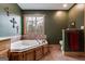 Bathroom showcasing a relaxing soaking tub with wood trim at 630 Stoney Point Rd, Bowdon, GA 30108