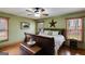 Inviting bedroom with wood trim, a ceiling fan, and windows that offer natural light at 630 Stoney Point Rd, Bowdon, GA 30108