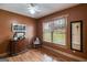 Bedroom featuring rustic wood floors, a window with natural light, and cozy decor at 630 Stoney Point Rd, Bowdon, GA 30108