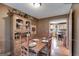 Cozy dining room with rustic wooden table, chairs, and charming built-in hutch with decorative items at 630 Stoney Point Rd, Bowdon, GA 30108