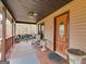 Inviting front porch with rustic decor and comfortable seating, ideal for outdoor relaxation at 630 Stoney Point Rd, Bowdon, GA 30108