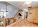 Hallway with hardwood floors, wooden railing, and a ceiling fan at 630 Stoney Point Rd, Bowdon, GA 30108