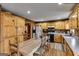Spacious kitchen featuring wood cabinets, a large dining table, and modern appliances at 630 Stoney Point Rd, Bowdon, GA 30108