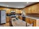Bright kitchen features wood cabinetry, stainless steel appliances, and an inviting eat-in area at 630 Stoney Point Rd, Bowdon, GA 30108