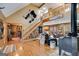 Open-concept living room with hardwood floors, a fireplace, and stairs leading to the second level at 630 Stoney Point Rd, Bowdon, GA 30108