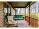 Cozy porch with wooden railing and a swing, offering a comfortable outdoor seating area at 630 Stoney Point Rd, Bowdon, GA 30108