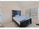 Cozy bedroom featuring plush carpeting, natural light, and a modern black bed frame at 95 Sylvan Loop, Fayetteville, GA 30214