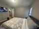 Bedroom with ceiling fan, window and attached bathroom featuring a modern aesthetic at 4043 Windgrove Xing, Suwanee, GA 30024