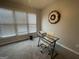 Simple bedroom with carpet, desk, and natural light from large windows at 4043 Windgrove Xing, Suwanee, GA 30024