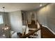 Bright hallway features wood floors, white railings, and an elegant light fixture at 4043 Windgrove Xing, Suwanee, GA 30024