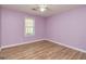 Empty bedroom has lovely hardwood flooring and is painted a lovely shade of lilac at 15 Beaver Creek Run, Sharpsburg, GA 30277