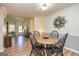 Bright dining room featuring modern decor, wood flooring and a round wooden dining table at 15 Beaver Creek Run, Sharpsburg, GA 30277