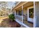 Cozy front porch with white railings and a 'Welcome Spring' sign adding charm to the home's exterior at 15 Beaver Creek Run, Sharpsburg, GA 30277