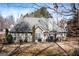 Backyard view of a house with large windows, grill, and gazebo with a table and chairs at 150 Valley Bluff Dr, Fayetteville, GA 30215