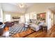 Cozy living room featuring a fireplace, hardwood floors, high ceilings, and lots of natural light at 150 Valley Bluff Dr, Fayetteville, GA 30215