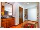 Hallway with a wet bar, wood floors, staircase, and access to the kitchen at 2191 Spear Point Dr, Marietta, GA 30062