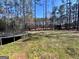 Large, grassy backyard with mature trees and a trampoline, offering plenty of space at 175 Monarch Dr, Peachtree City, GA 30269