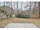 Backyard with a patio and surrounding trees and manicured bushes at 40 High St, Sharpsburg, GA 30277